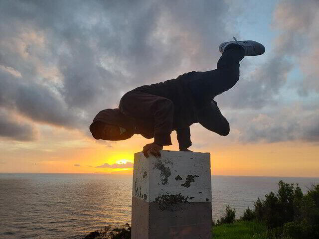 Doing a bboy freeze overseas in Madeira during the sunrise.